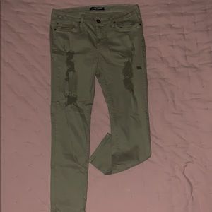 Olive green ripped jeans.